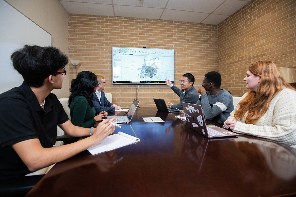 Dr. Yang Zhou and Dr. Michael Carroll with student researchers 