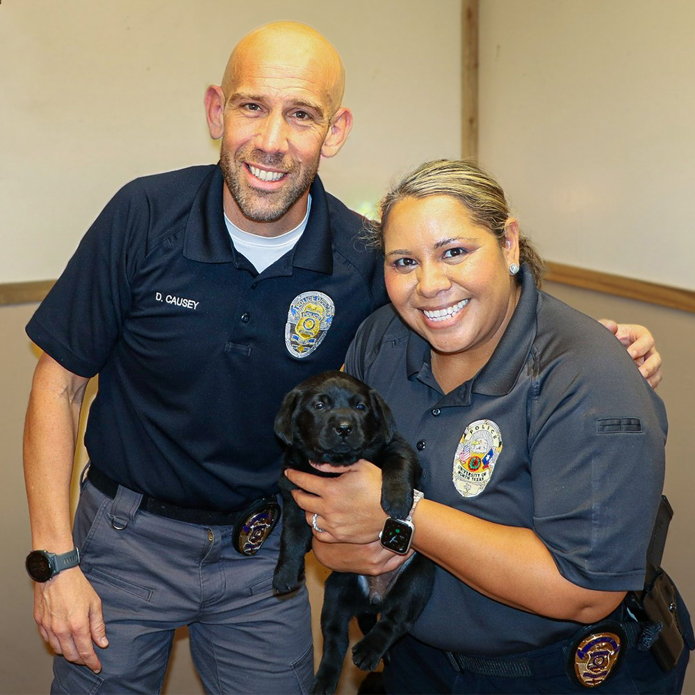 Corporal David Causey (left) with Chief Ramona Washington (right) picking out UNT Police’s new community support dog 