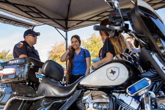 Officers Explain Their Motorycle and Talk About a Career in Law Enforcement with a Student