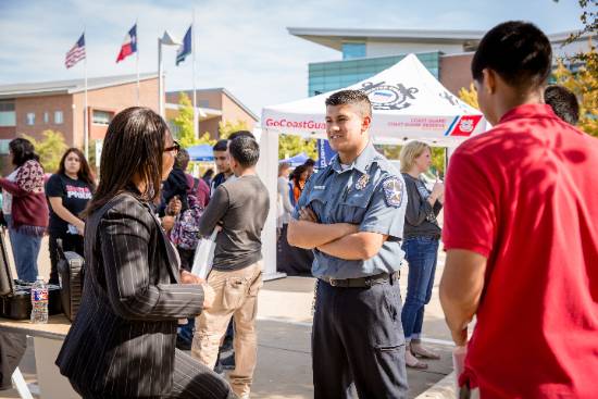 Guests Visit with a Police Officer at a UNT Dallas Campus Public Safety Event 