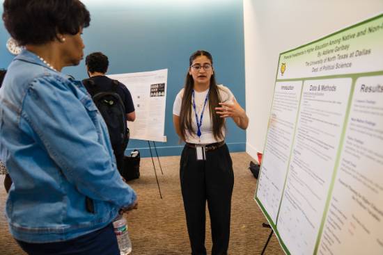 Adilene Garibay Explains Her Research Project to Provost Betty Stewart During the UNT Dallas Student Research Symposium 