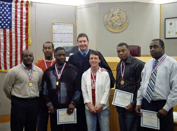 Judge Robert Francis with Graduates of a Drug Probation Program (Source: Reentry Court Solutions) 