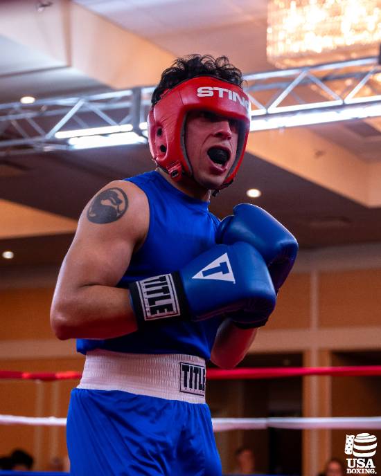 Noe Mendoza, a 2L Student at UNT Dallas College of Law, in the Boxing Ring During a Collegiate Match 