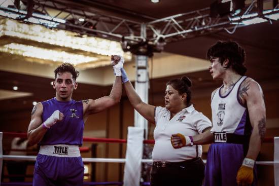 A Referee Declares Noe Mendoza the Winner of a National Collegiate Boxing Tournament 