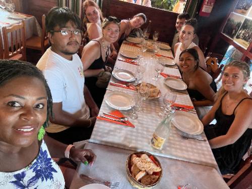 UNT Dallas Students Chetavua Bell and Luis Espinoza (far left) Prepare to Enjoy a Traditional Spanish Meal While Studying Abroad in the Summer of 2023