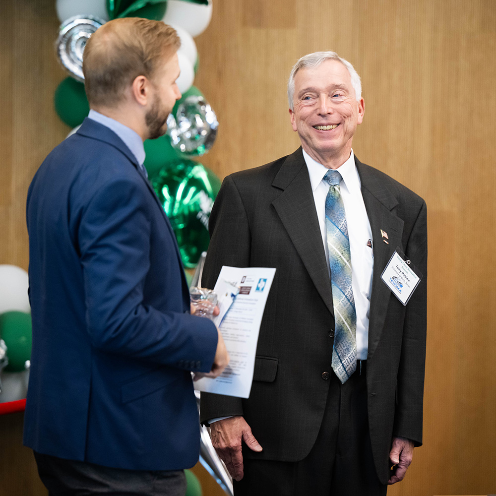 UNT's Terry Pohlen speaks with an NSF Supply Chain Innovation and National Security Summit attendee